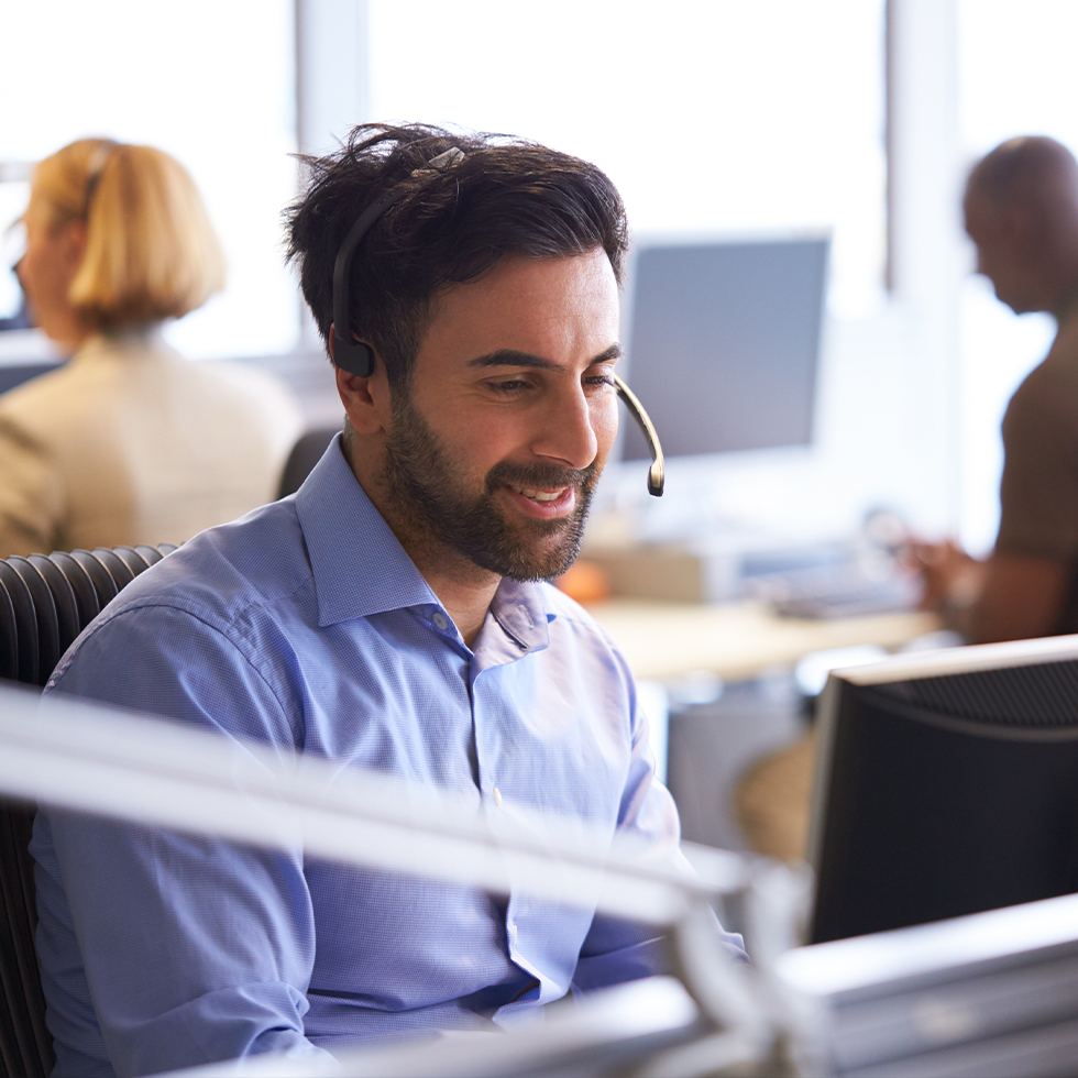 Man in office answering the telephone